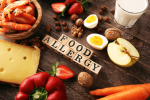 Allergy food concept. Allergy food as almonds, milk, cheese, strawberry, seeds, eggs, peanuts and crustaceans or shrimps